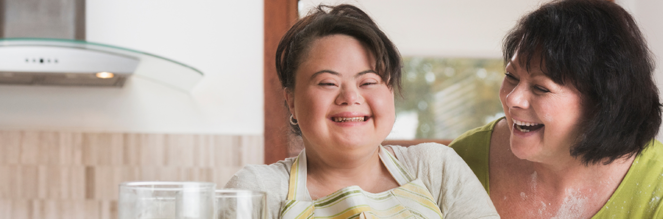 Two women cooking and laughing